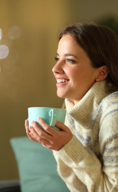 smiling woman holding coffee